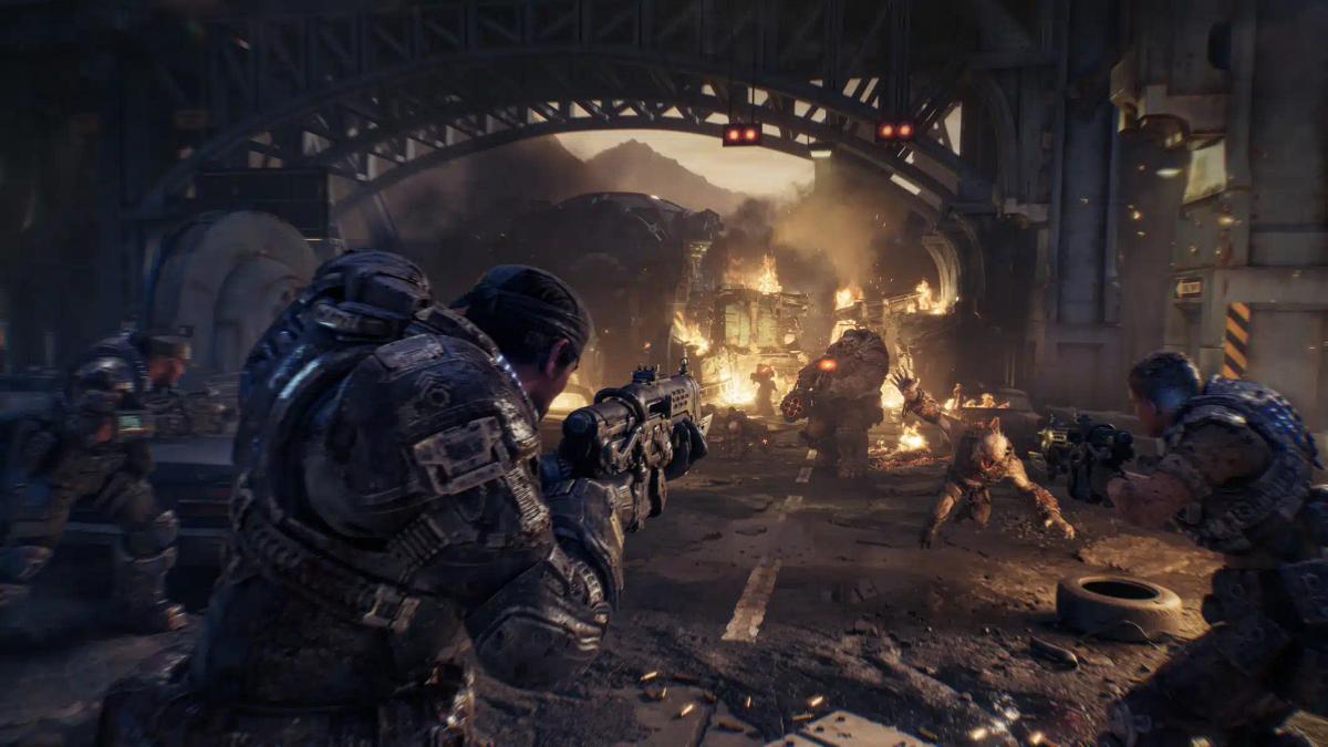 Mga sundalong naka-heavy armor habang nakikipaglaban sa mga halimaw sa isang gumuhong lungsod mula sa Gears of War: E-Day.