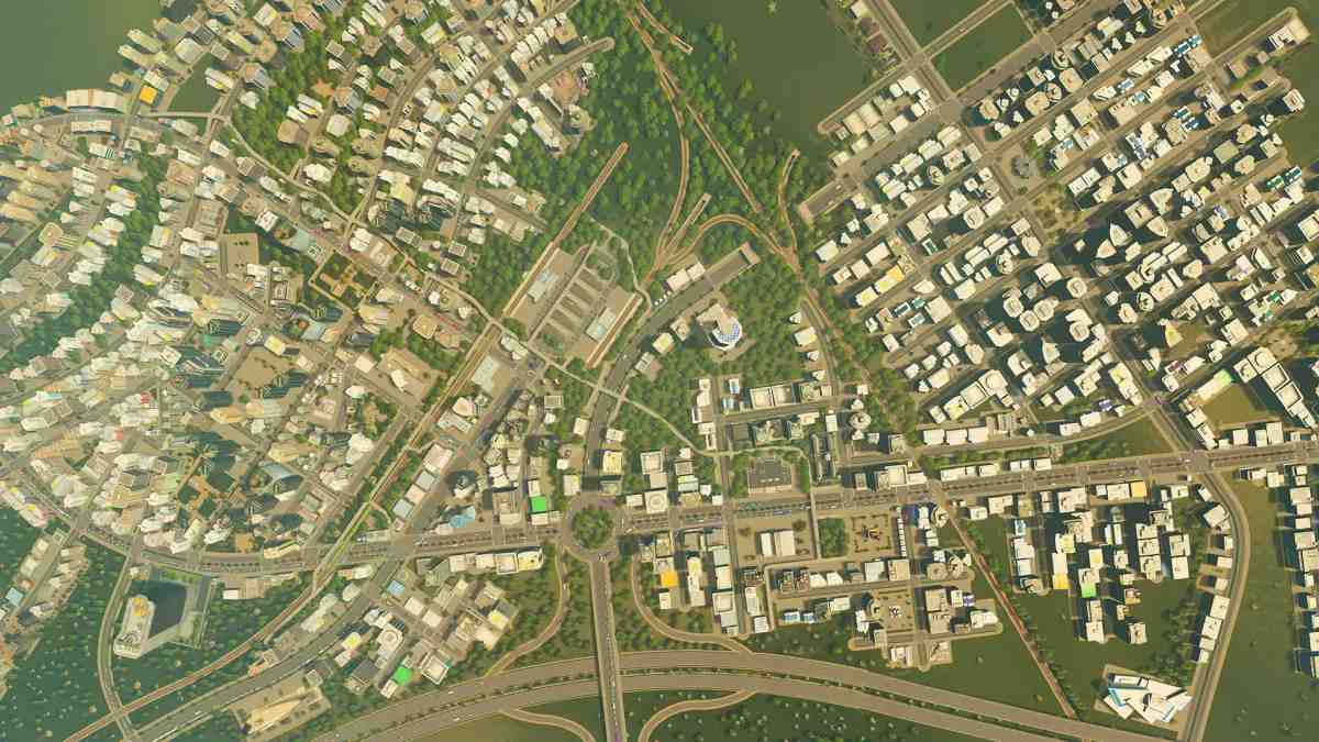 Isang high-angle na overview ng disenyo ng isang siksik na lungsod na may mga kalsada, at mga gusaling residential at komersyal sa Cities: Skylines